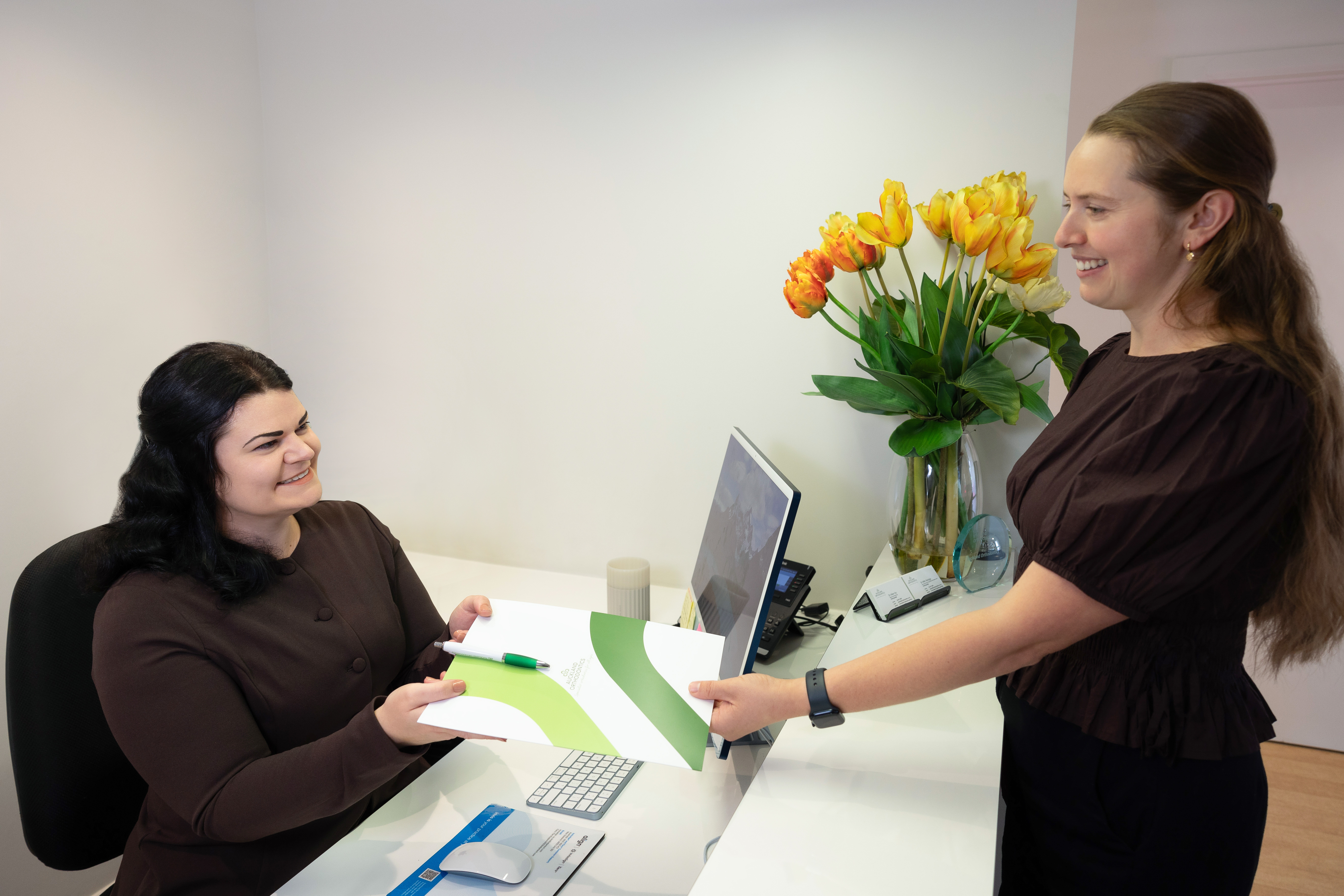 Receptionist greeting patient Receptionist greeting patient